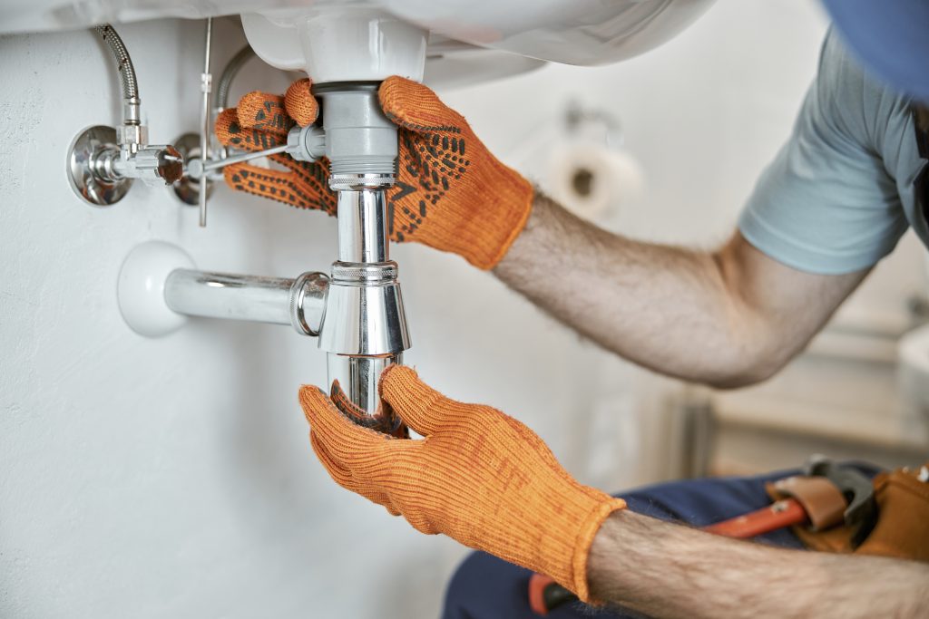 Plumber fixing a kitchen sink in Petaling Jaya