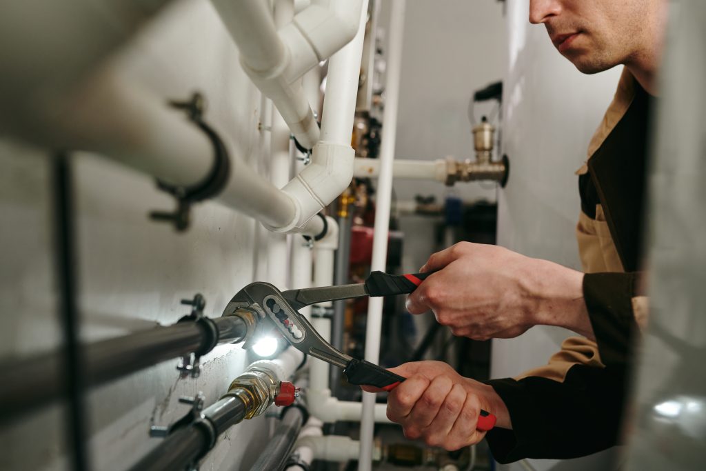 Plumber fixing a kitchen sink in Petaling Jaya