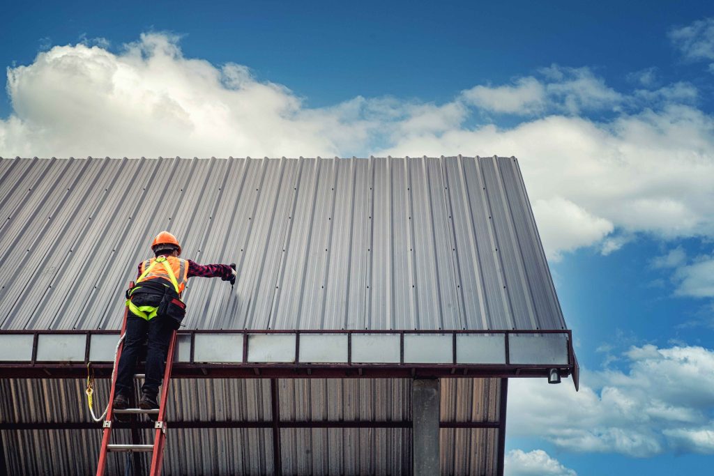 A professional in Petaling Jaya applying a high-quality roof coating for superior protection and longevity.